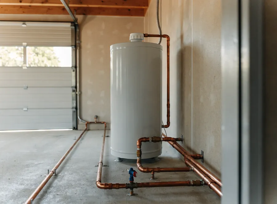 A new tank water heater installed in a garage